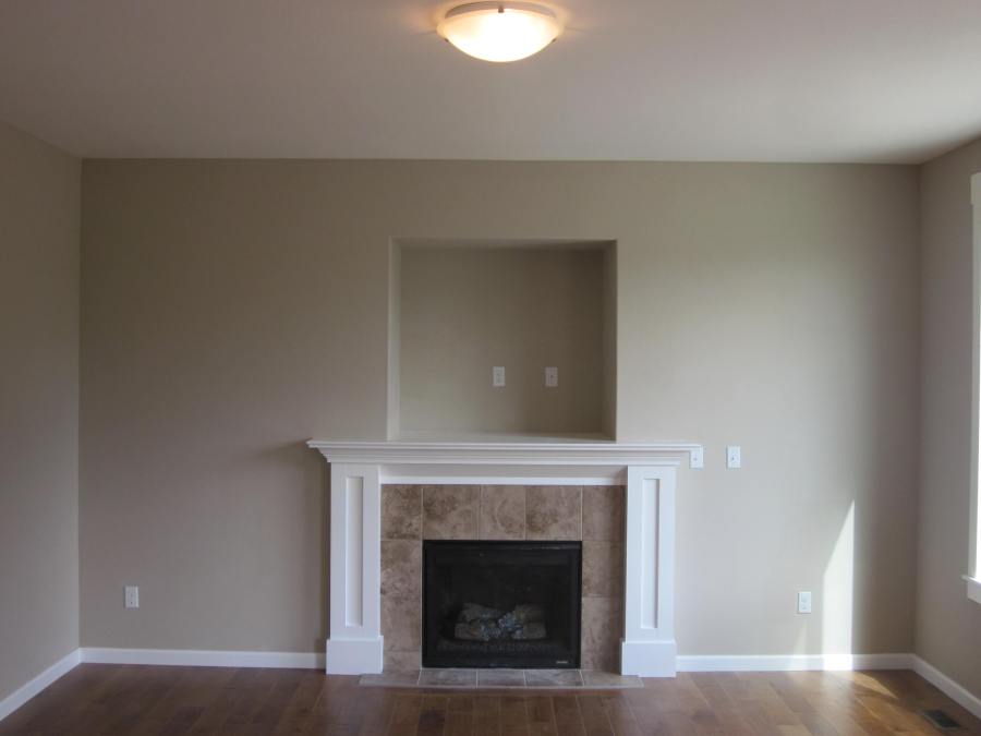 Fireplace with custom mantle, as viewed from the kitchen.